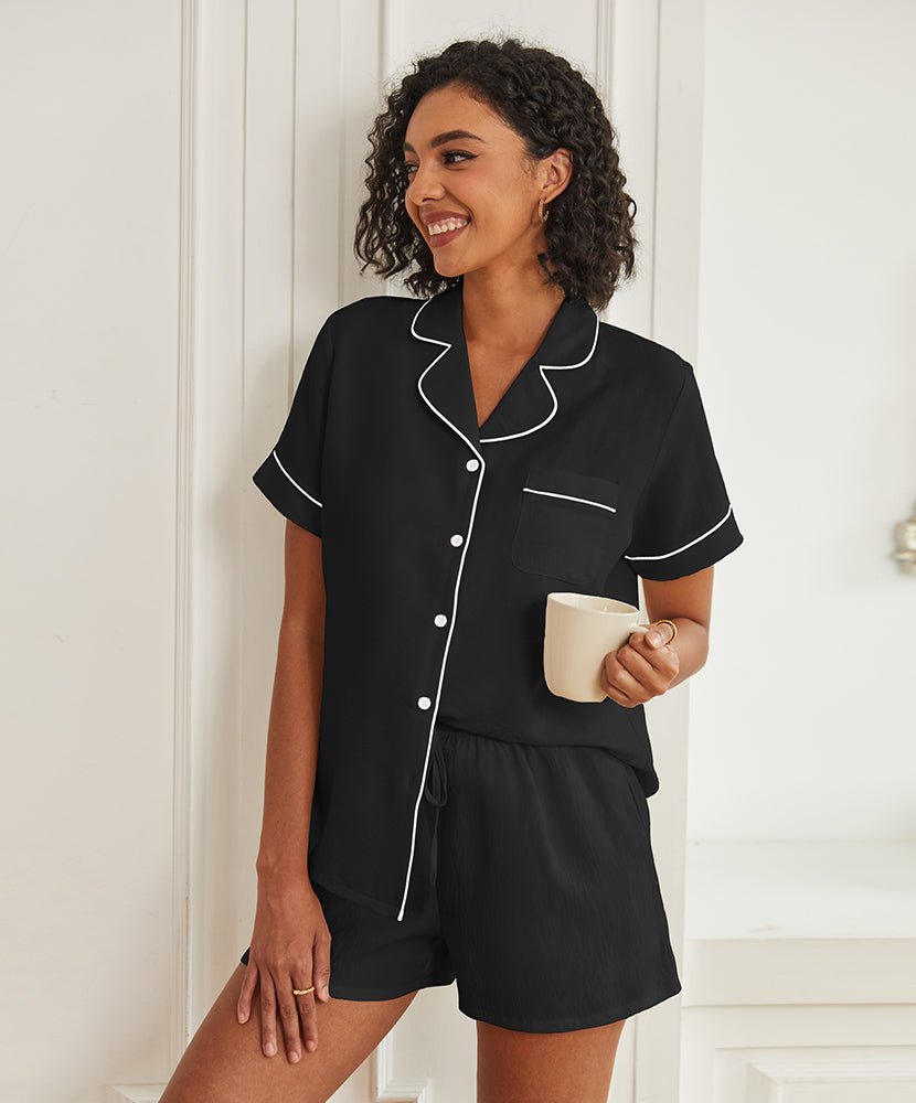 Black short-sleeve pajama set with button front, piped collar, and drawstring shorts.