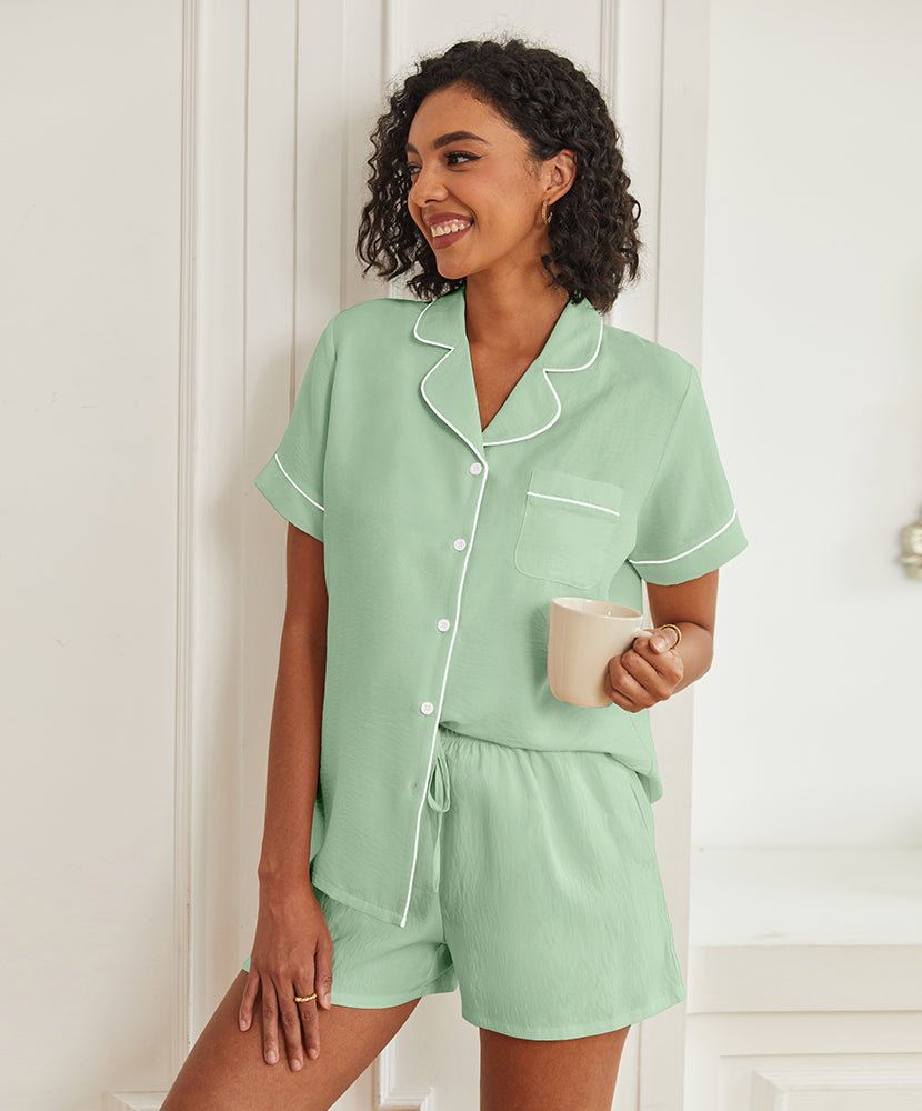 Green short-sleeve pajama set with button front, piped collar, and drawstring shorts.