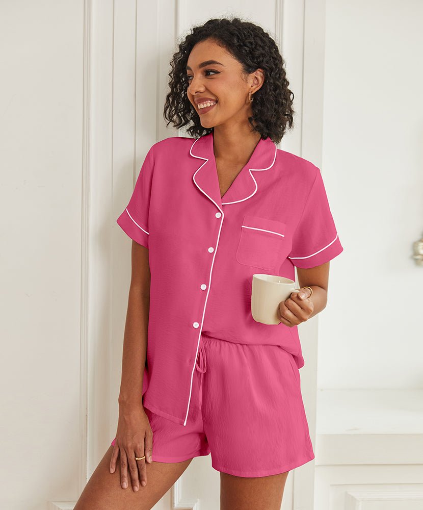 Hot pink short-sleeve pajama set with button front, piped collar, and drawstring shorts.