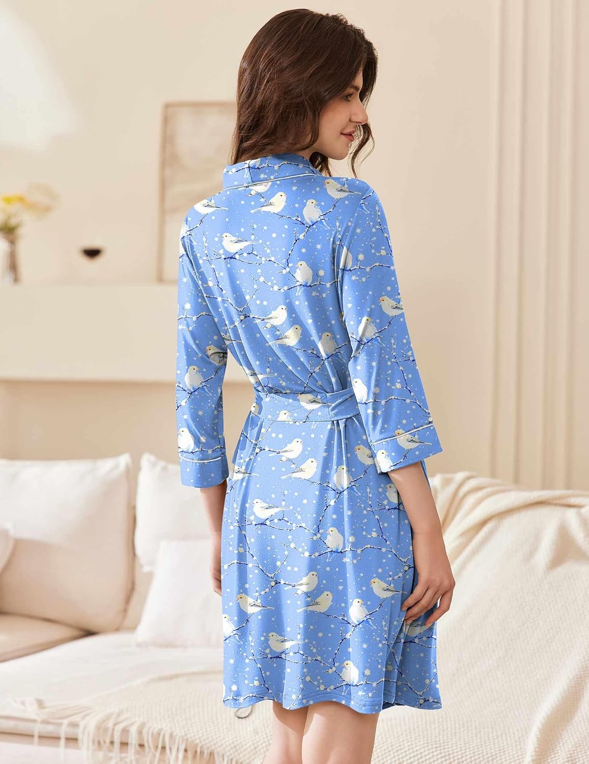 Back view of blue short kimono robe with white bird print, shawl collar and tie belt