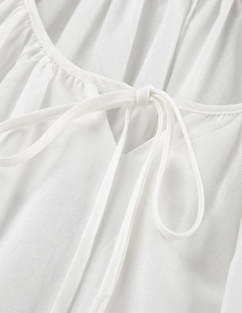 White cotton nightgown close-up of drawstring tie at gathered neckline