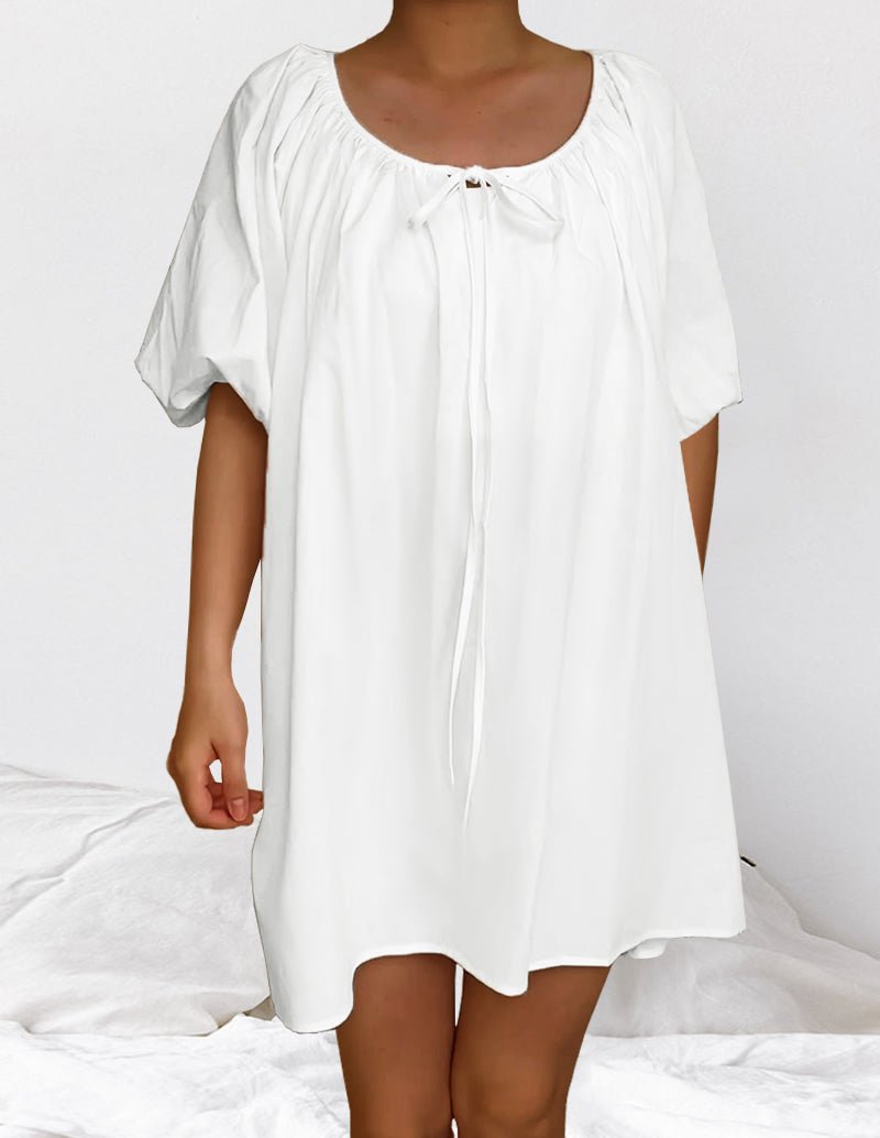 White cotton nightgown with round neckline, gathered yoke, and loose short sleeves