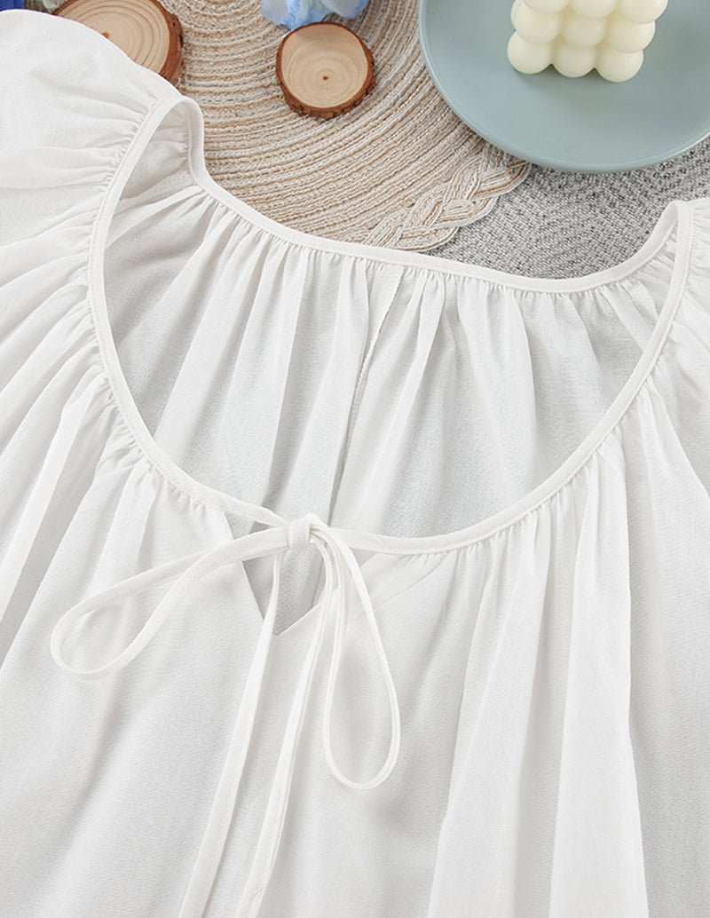 White cotton nightgown neckline with drawstring tie and gathered bib detail