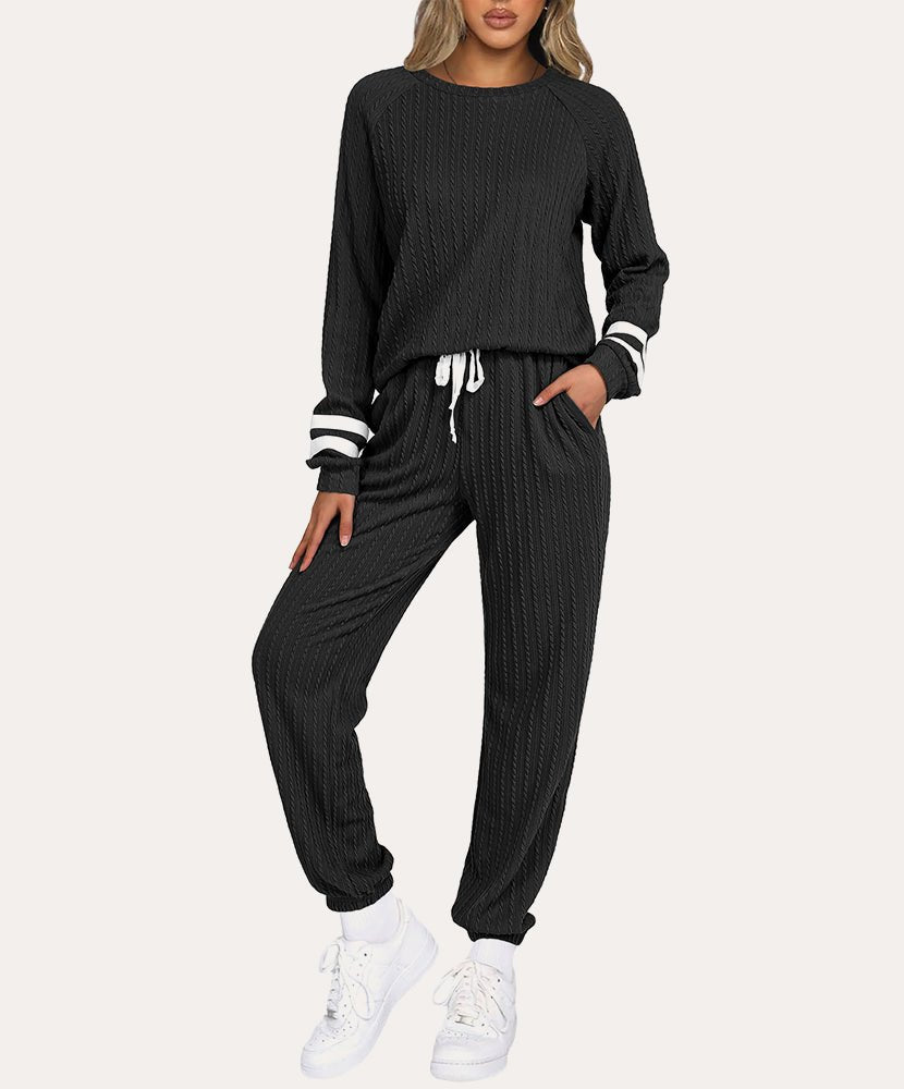 Black ribbed knit lounge set with long sleeves, striped cuffs, and drawstring jogger pants