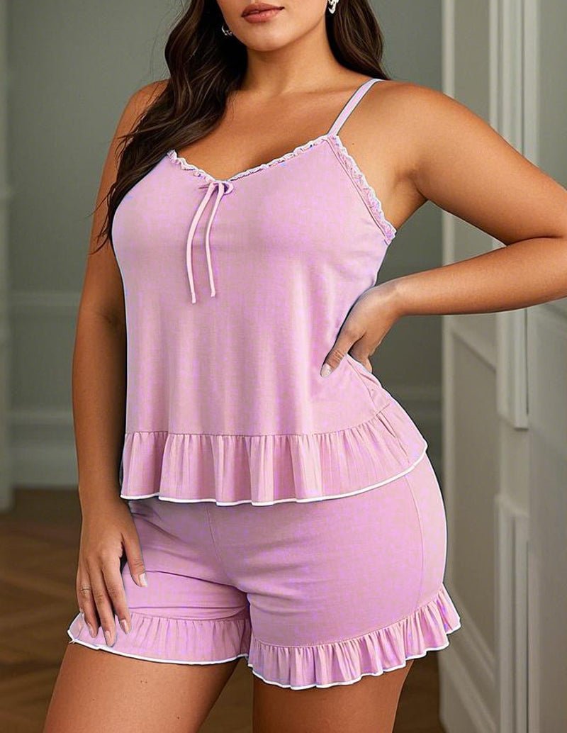 Pink cami pajama set with lace-trim neckline, tie straps, and ruffle shorts