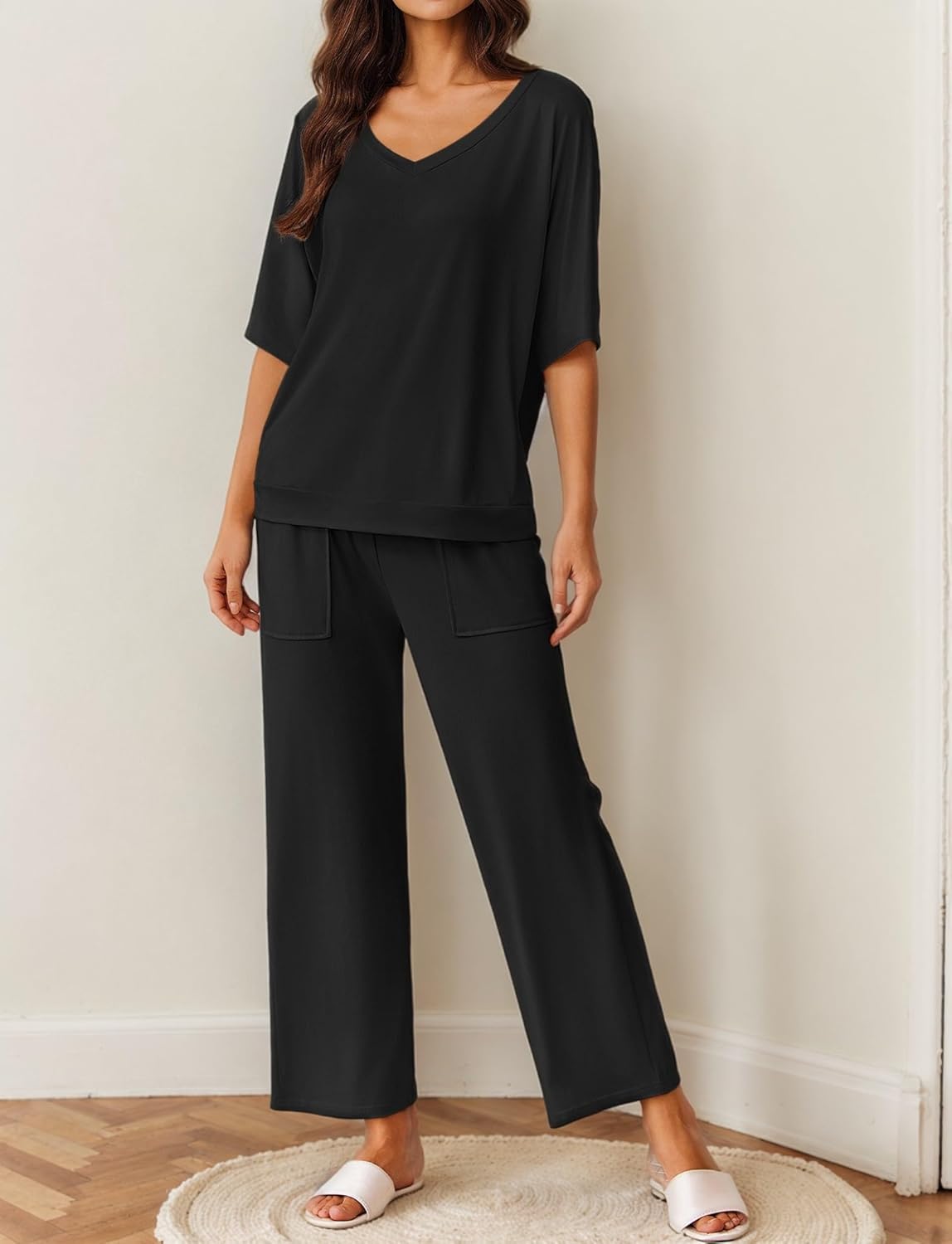Black pajama set with V-neck short-sleeve top and wide-leg pants, front pocket detailing