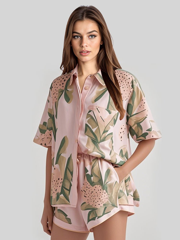 Pink leaf-print satin lounge set with short-sleeve shirt and matching shorts