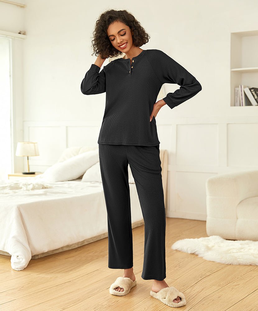 Black waffle-knit pajama set with quarter-zip top and straight-leg pants