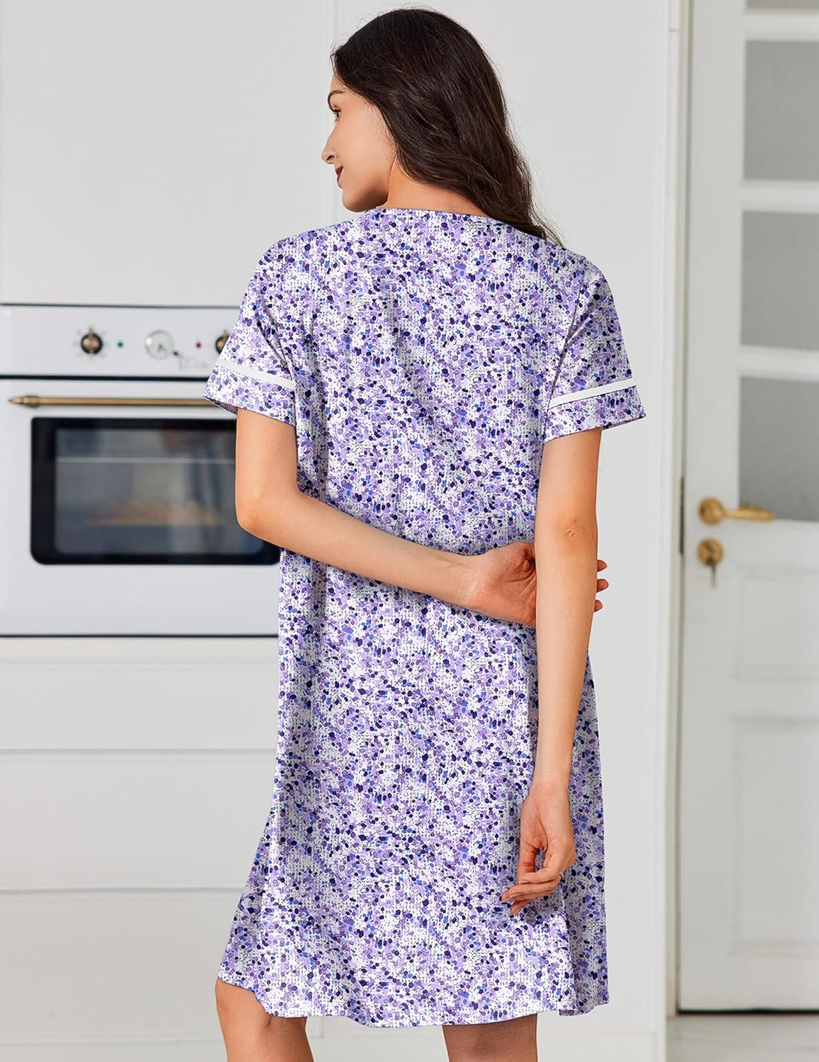 Back view of cotton button-front nightgown with pockets, short sleeves, purple floral