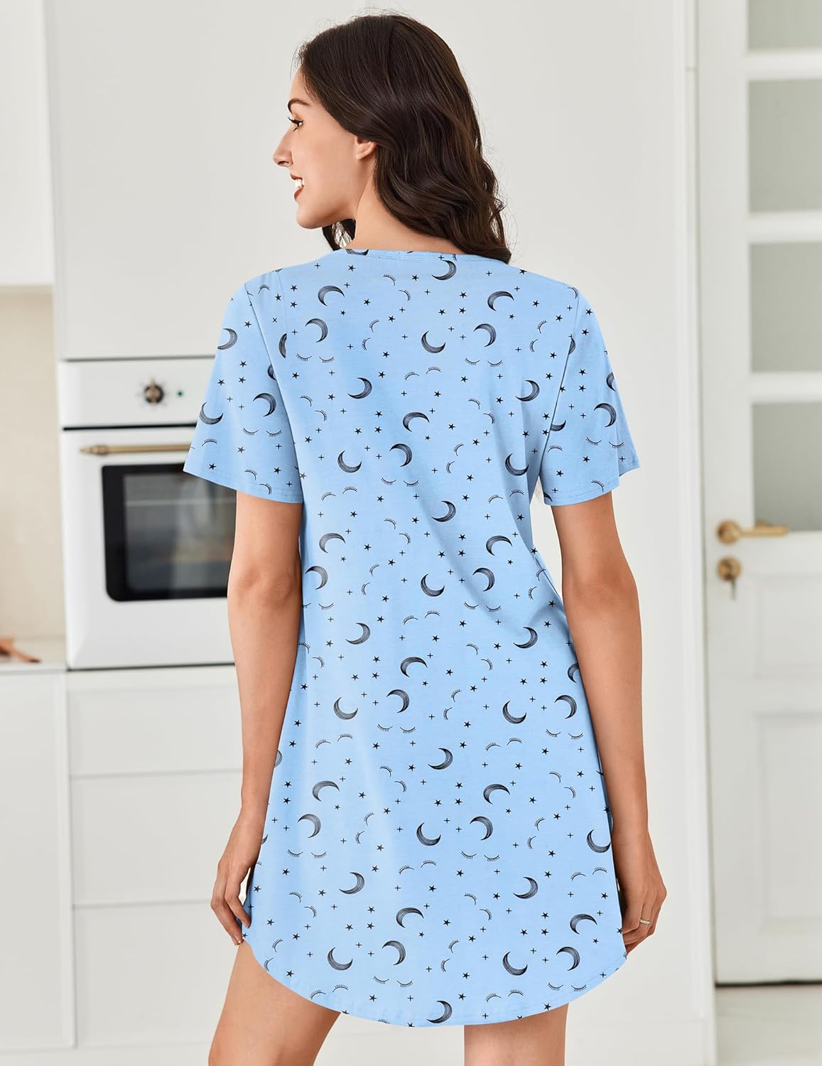 Back view of blue star-and-moon cotton nightgown, short sleeves and curved hem