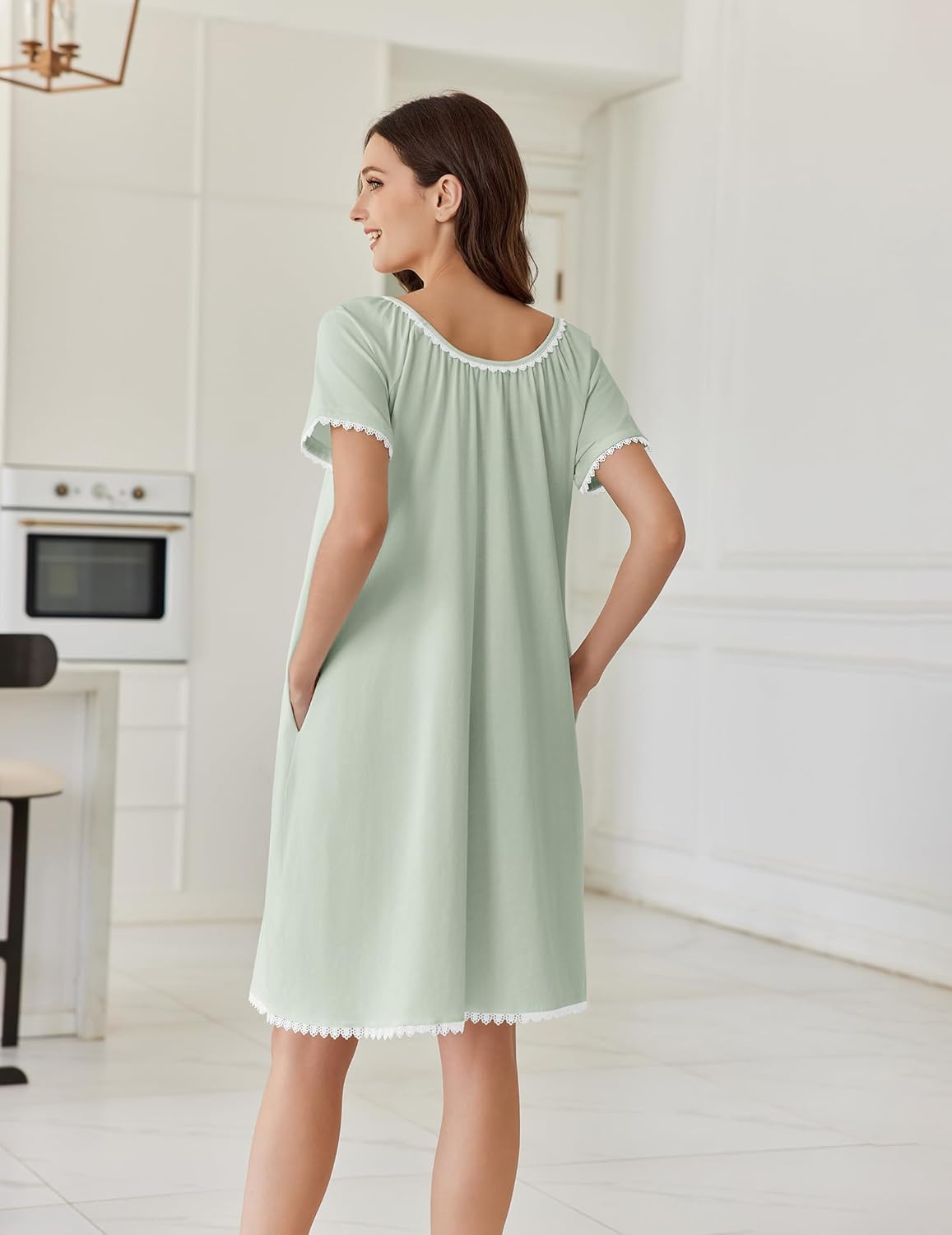 Light green short-sleeve cotton nightgown with lace trim around neckline and hem