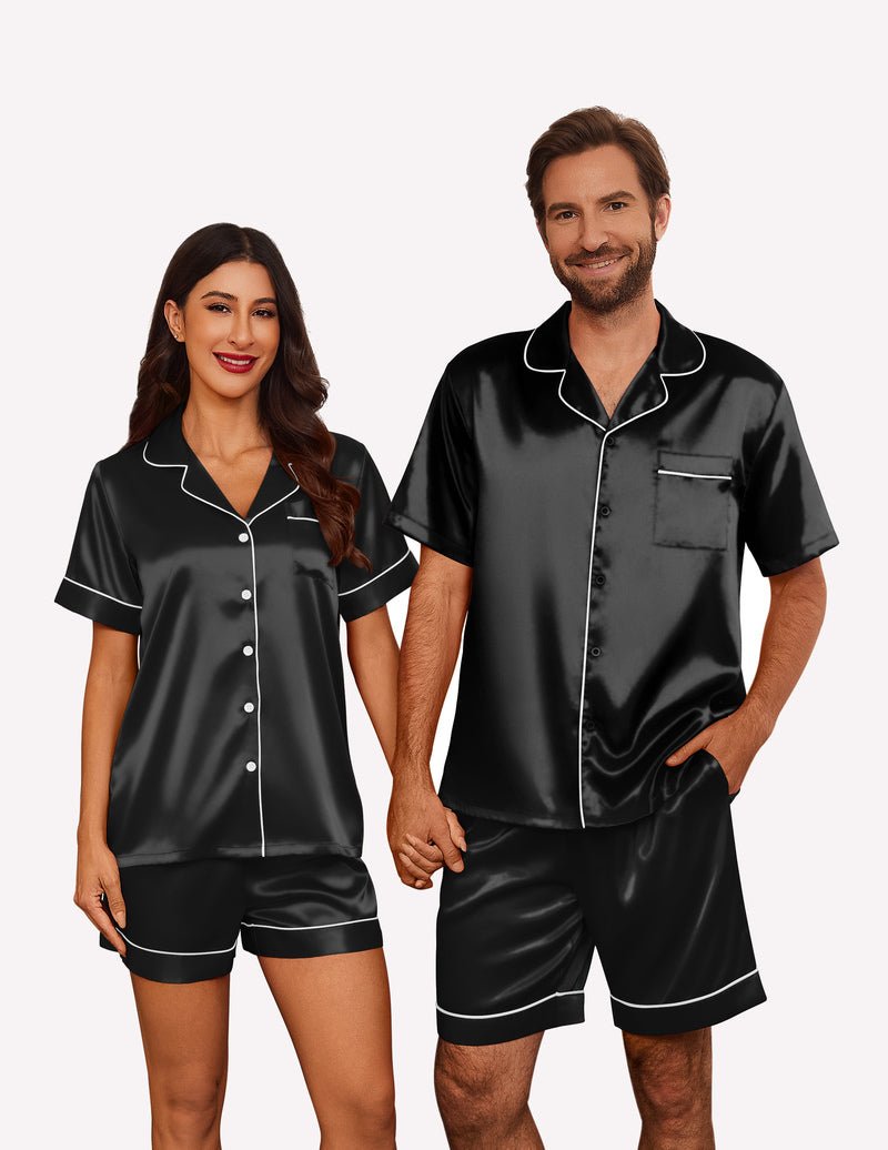 Black satin pajama set for couples: short-sleeve button shirt and matching shorts with trim.