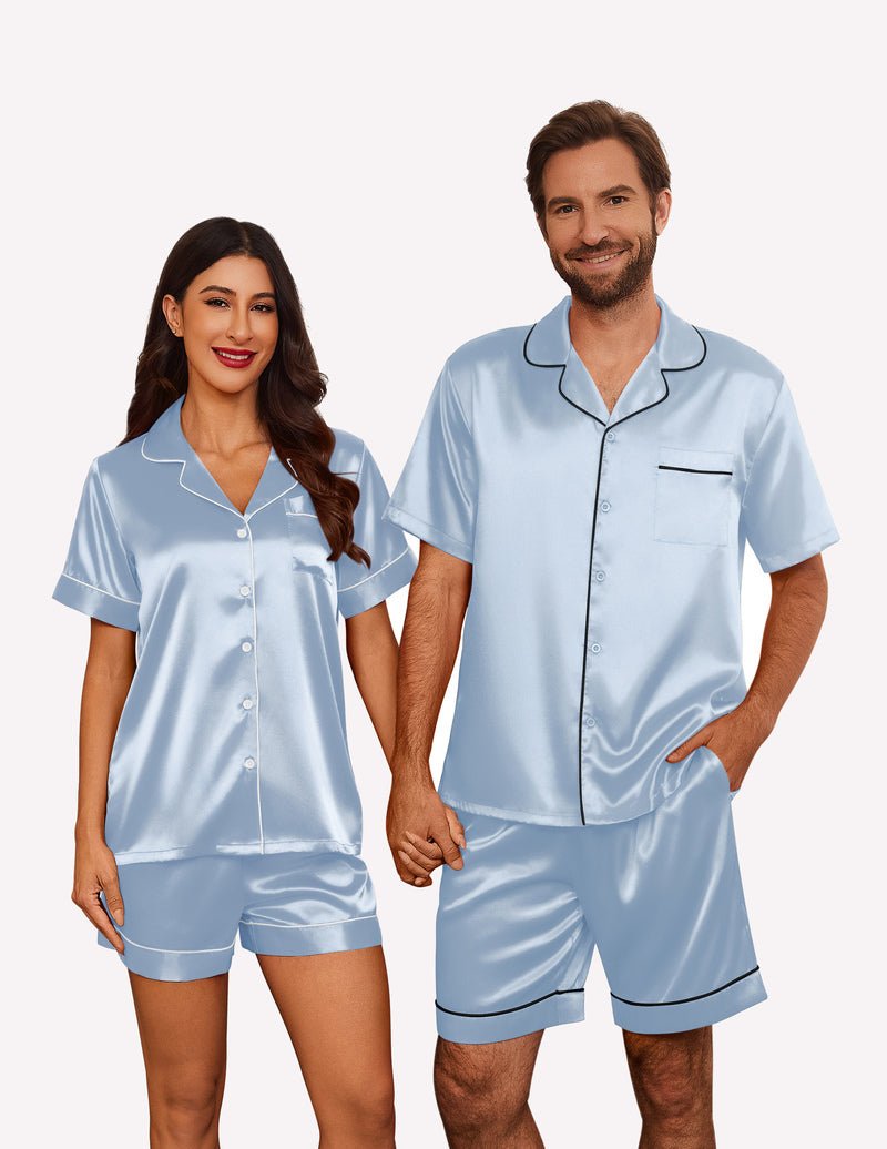 Light blue satin pajama set for couples: short-sleeve button shirt and matching shorts.