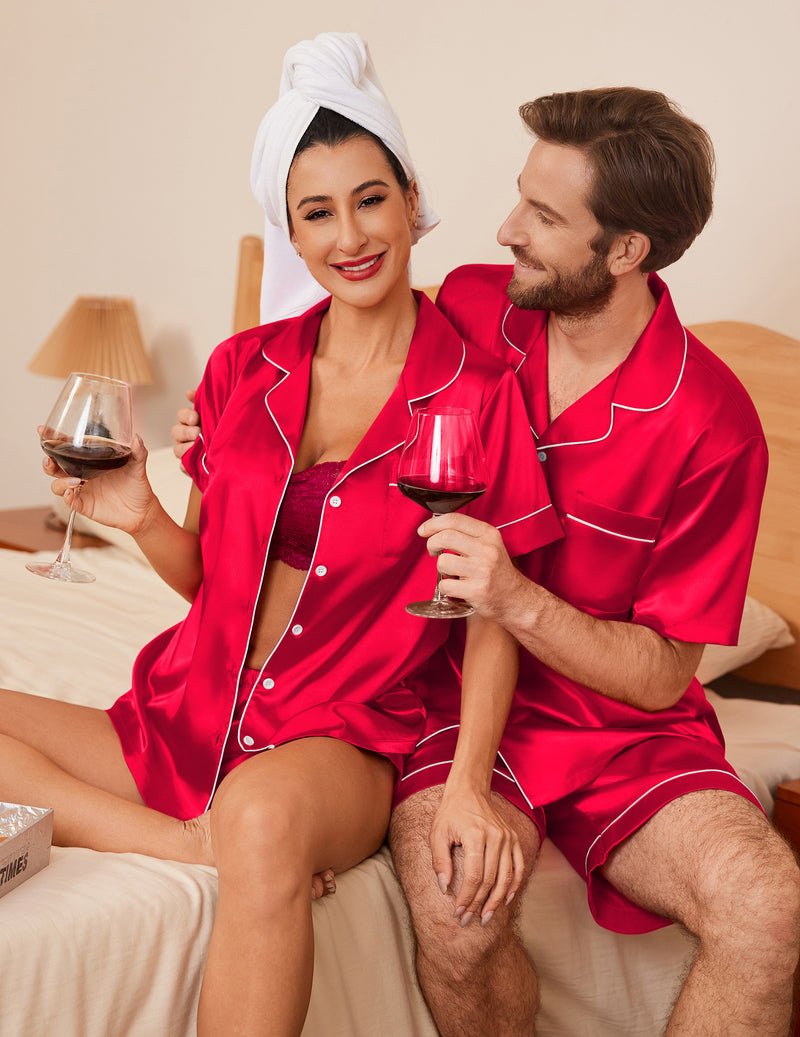 Red silk-satin pajama set: short-sleeve button front top and shorts with white trim.