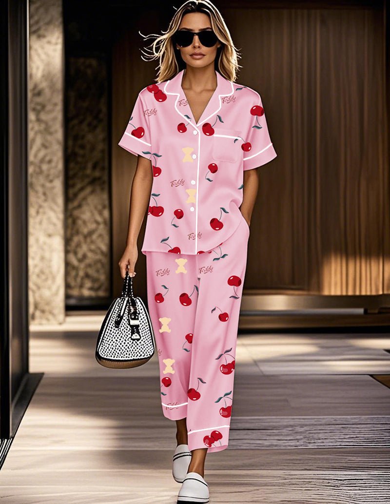 Pink cherry satin pajama set with short-sleeve button top and matching cropped pants