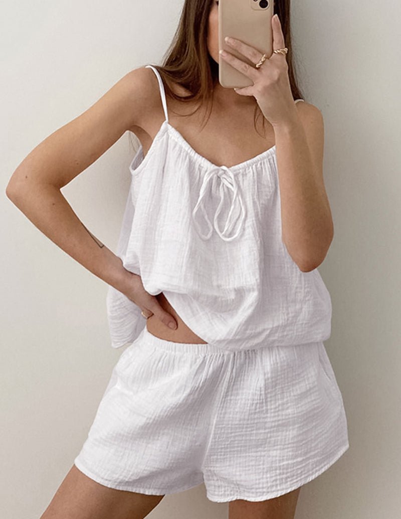 White cotton pajama set with cami top and matching shorts, worn by model