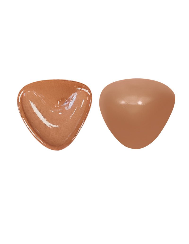 Self-adhesive chest pad pair, glossy caramel and tan triangular cups.