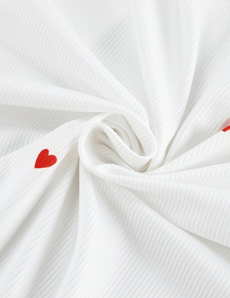 White lounge set fabric with vertical texture and small red heart print