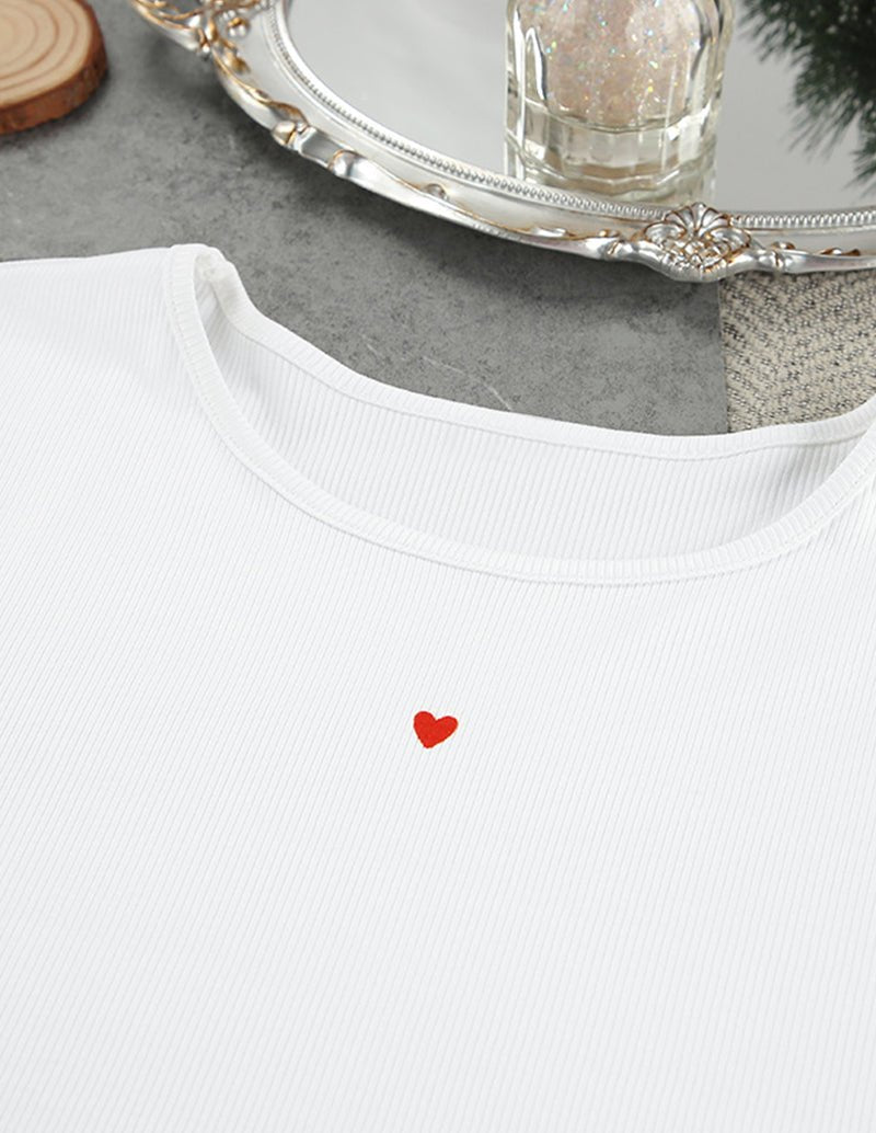 White lounge top neckline with red heart motif on ribbed knit fabric.