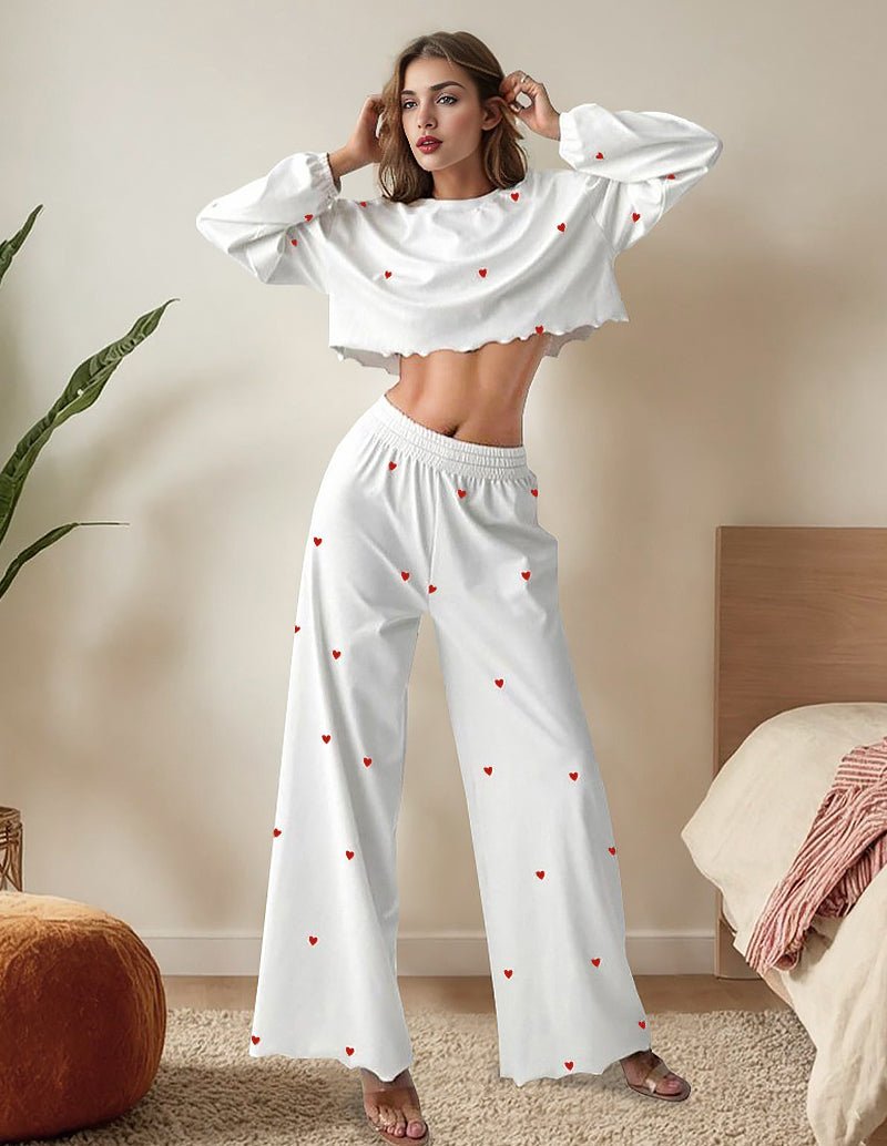 White lounge set with red heart print, ruffled cropped long-sleeve top and wide pants.