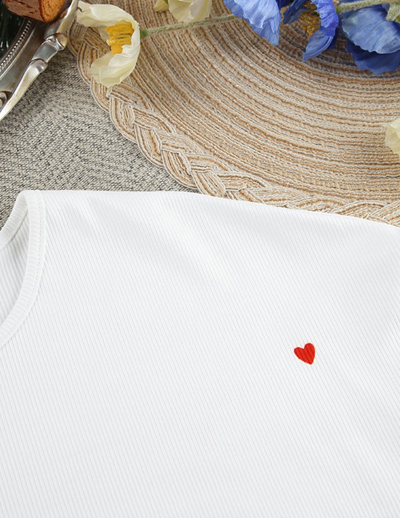 White lounge top with small red heart emblem on ribbed knit, crew neckline.