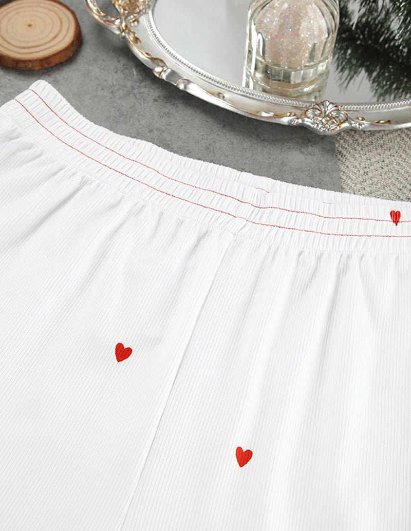 White lounge pants waistband with red heart print and ribbed trim.