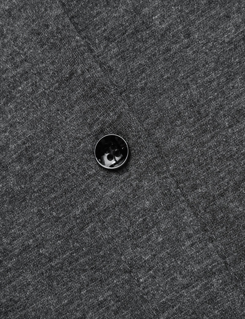 Dark grey sleep shirt button, black-trim edge and fabric texture close-up