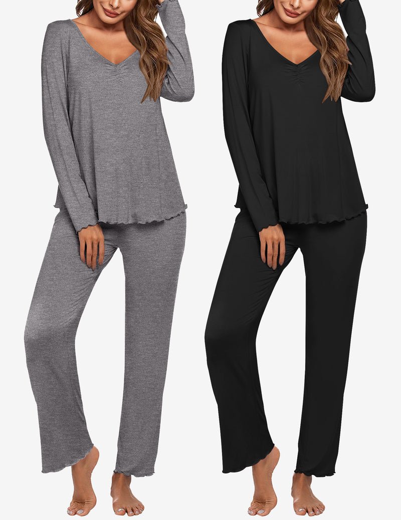 Two women’s long-sleeve pajama sets: heather gray and black V-neck tops with matching pants