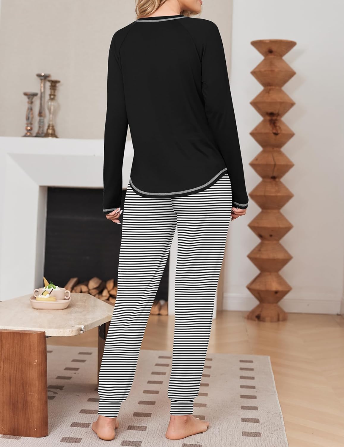 Long-sleeve black pajama top with black-and-white striped jogger pants