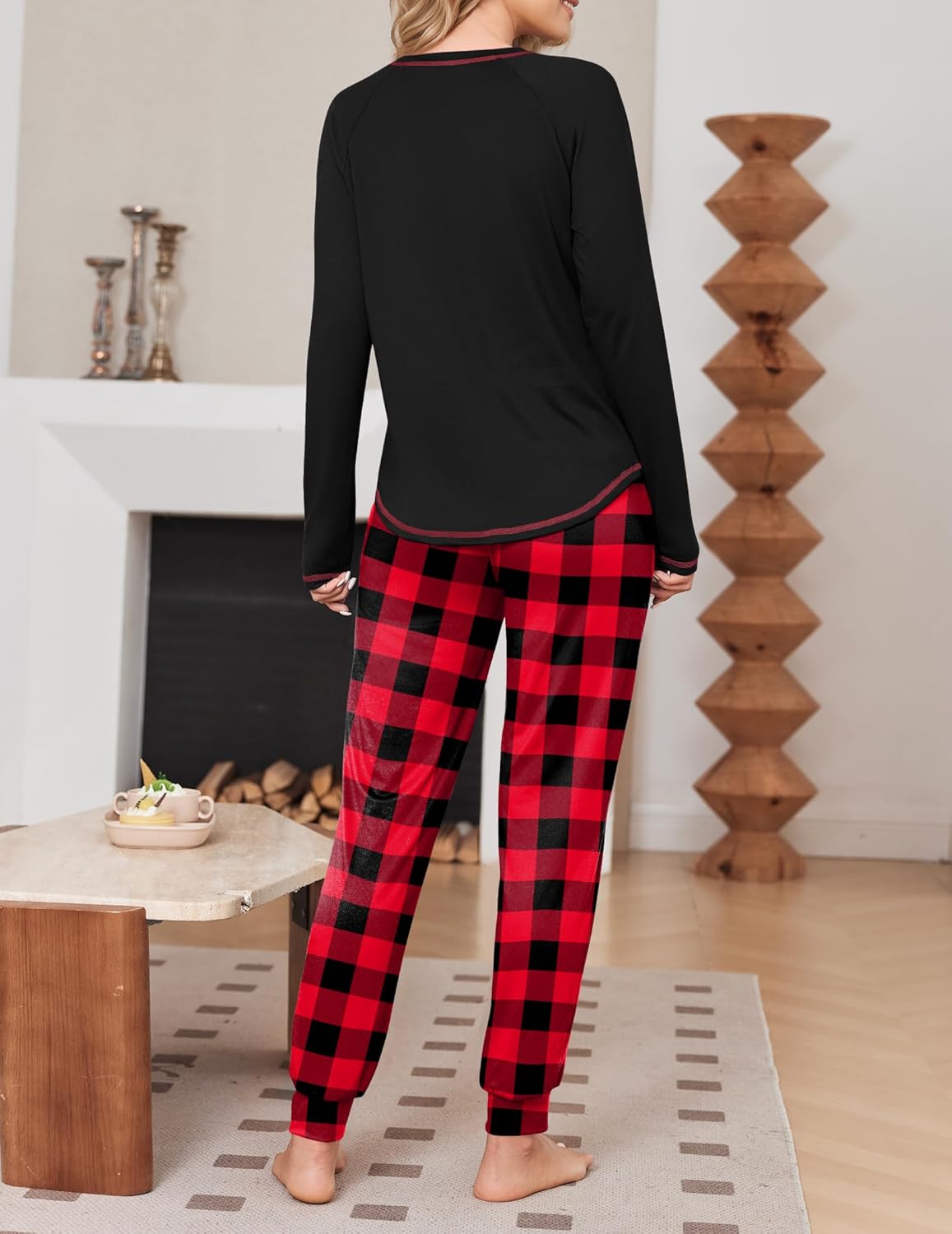 Black long-sleeve pajama top with red plaid jogger pants, back view