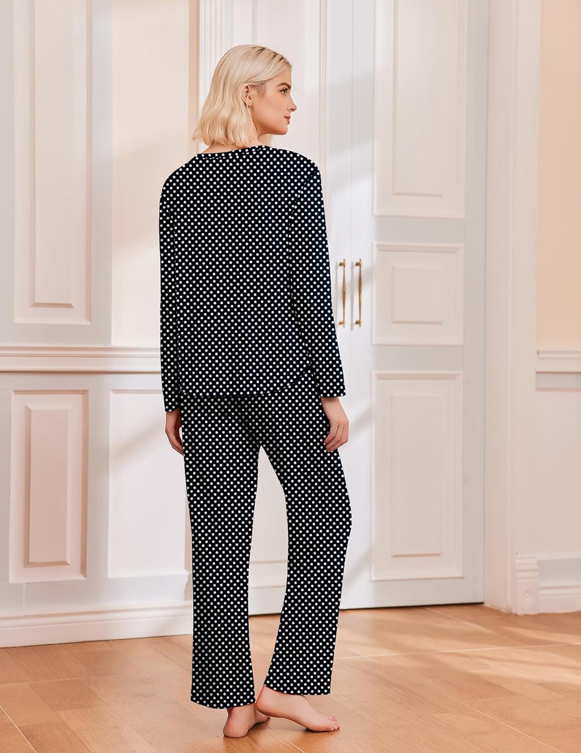 Black long-sleeve pajama set with white polka dots, matching top and pants