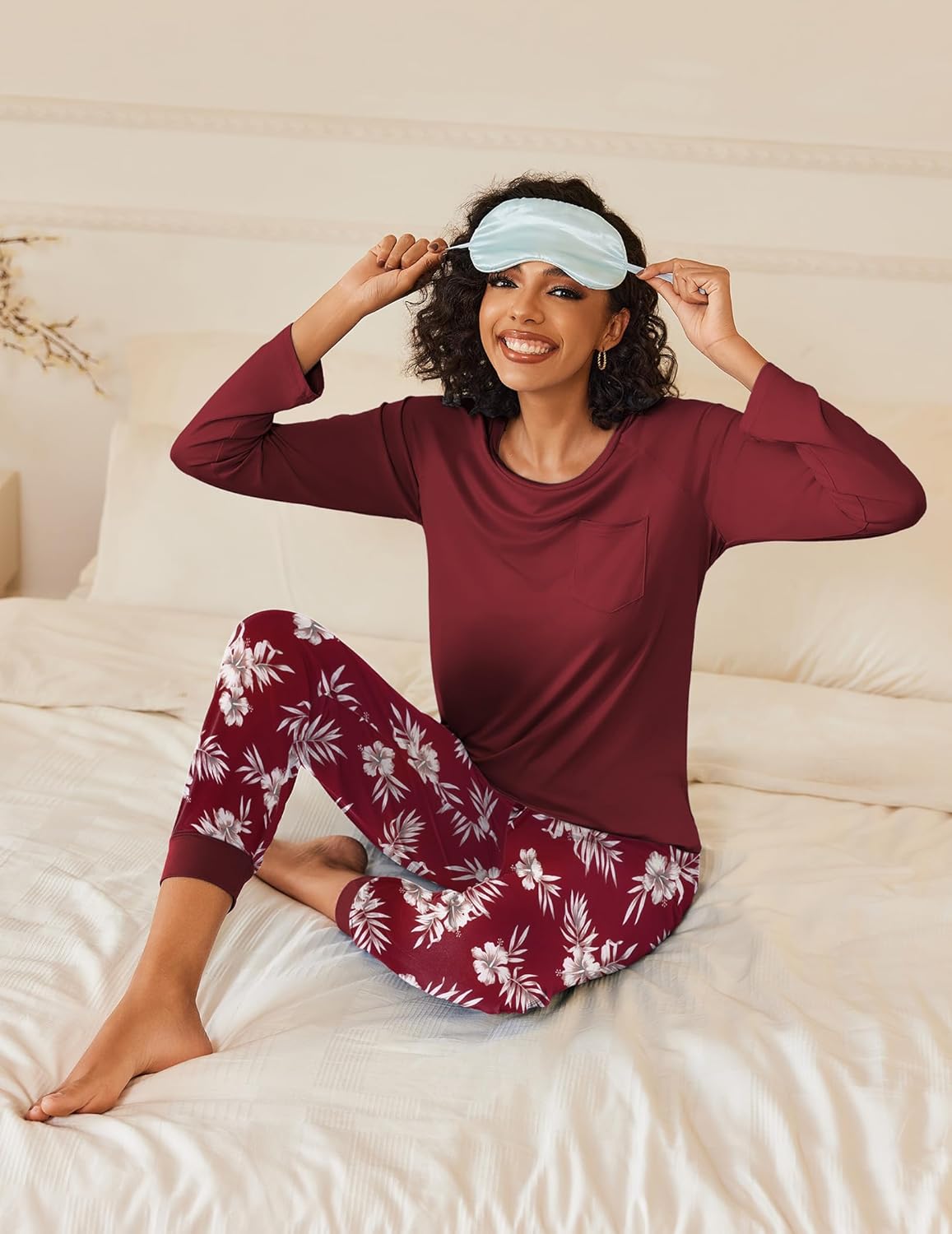 Burgundy long-sleeve pajama set with floral pants and light blue sleep mask
