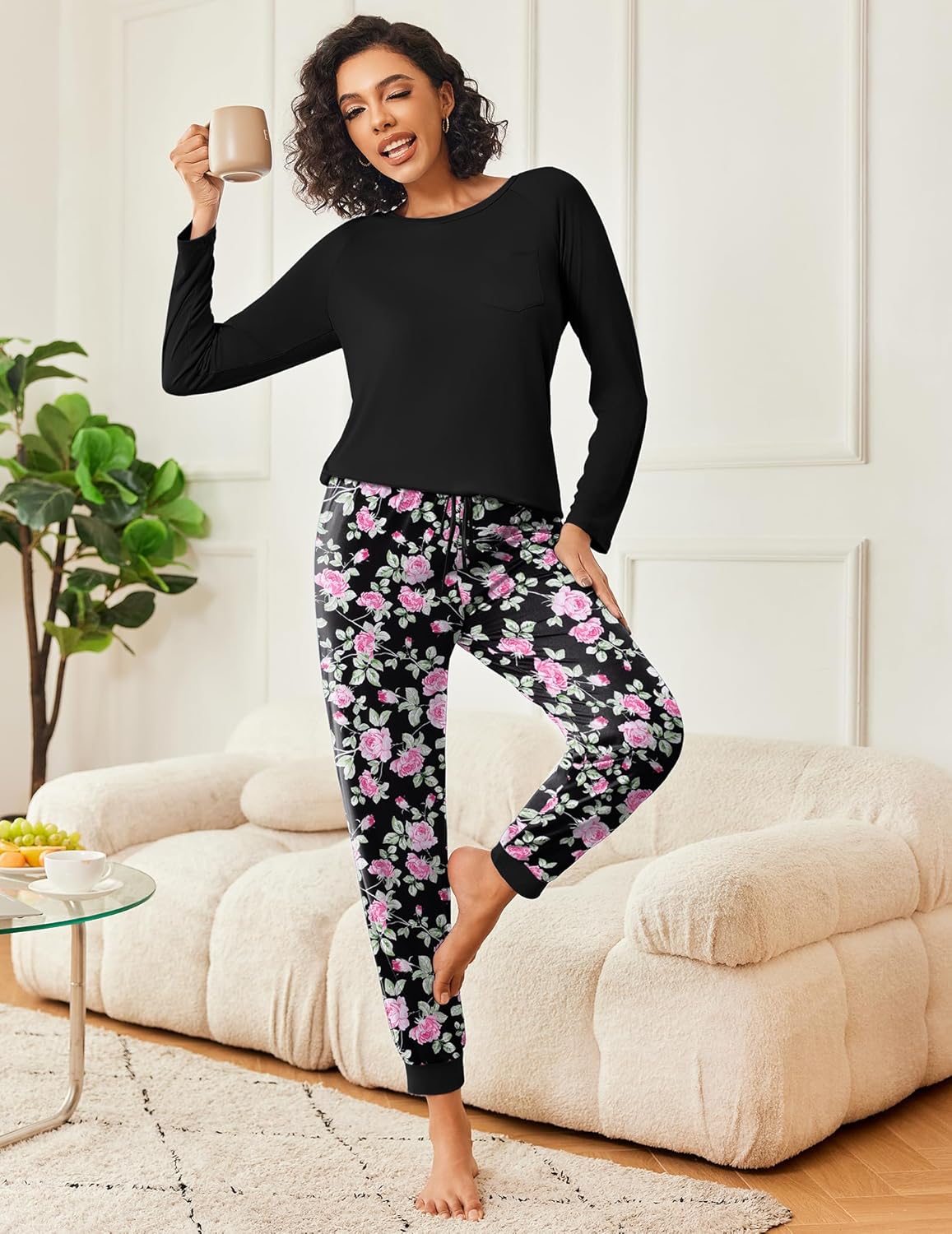Black long-sleeve pajama set with pink-and-white floral patterned lounge pants
