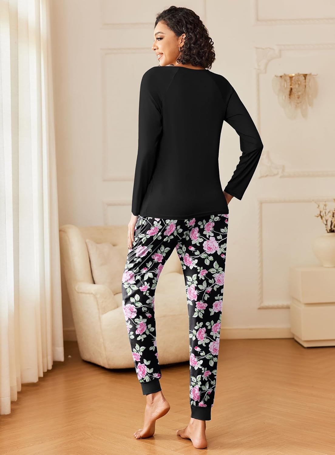 Black long-sleeve pajama top with pink-and-white floral print lounge pants