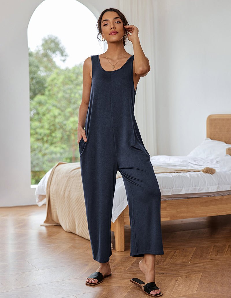 Navy sleeveless loose jumpsuit with wide legs, scoop neckline, front pockets
