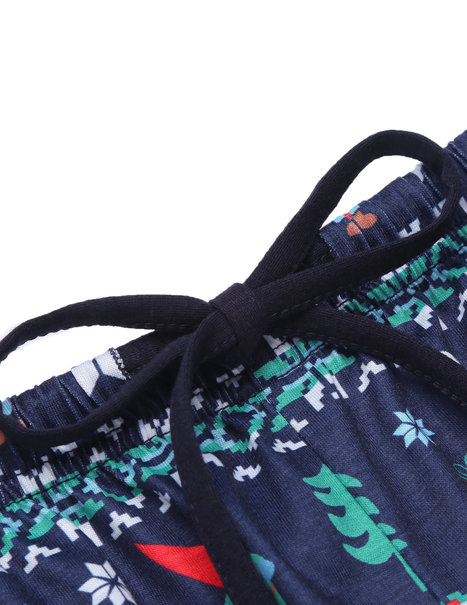 Navy pajama fabric detail: elastic waistband and holiday pattern close-up