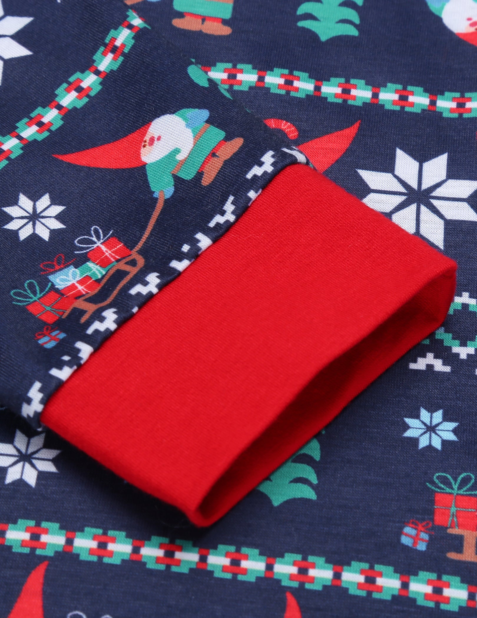 Navy pajama fabric folded, red and green holiday print panel