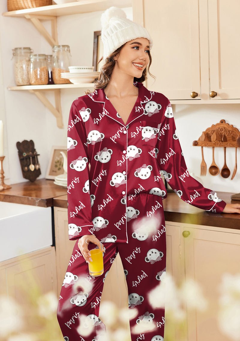 Burgundy satin pajama set with button-front top and allover cartoon print pants