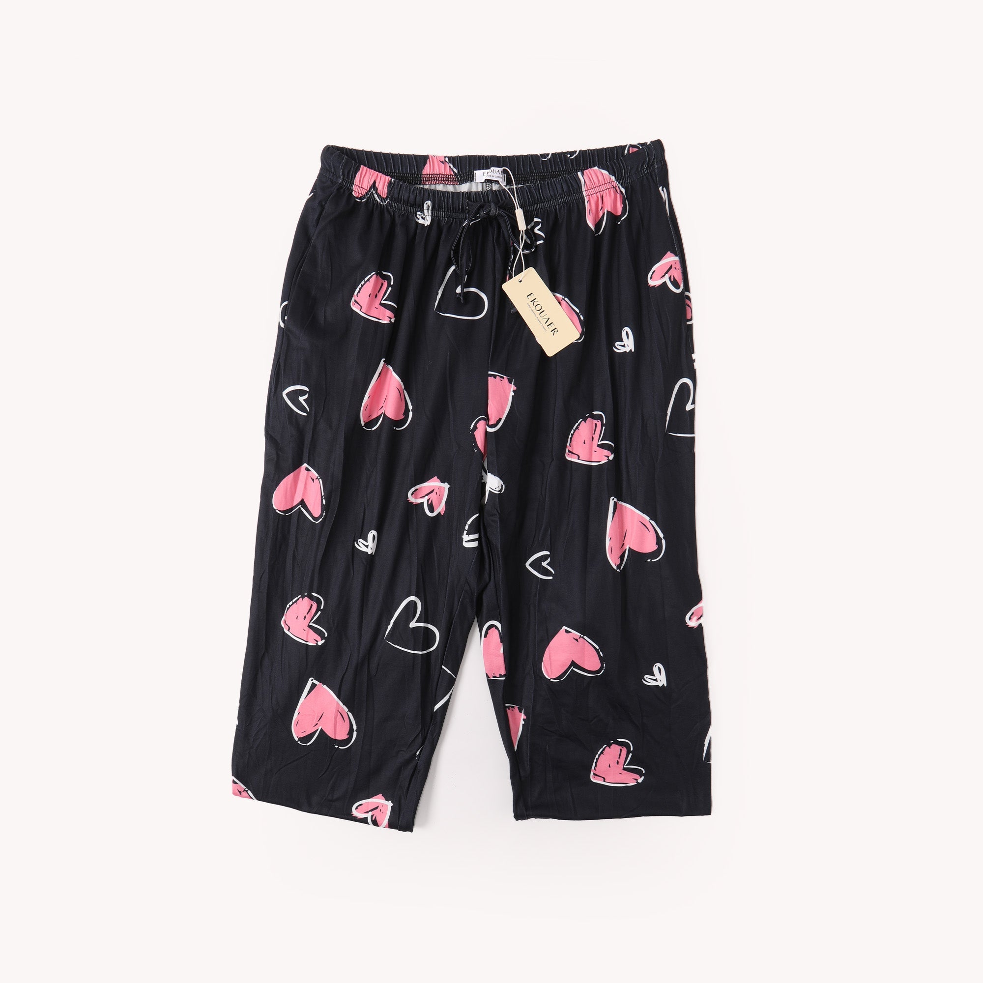 Black heart-printed pants with elastic waist and drawstring; pink hearts print