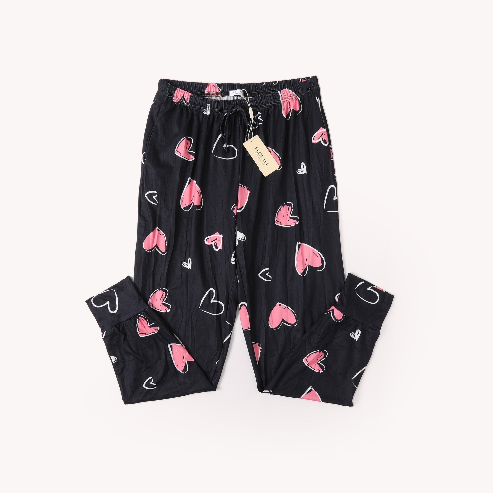 Black heart-printed pants with elastic waistband and drawstring; pink hearts allover