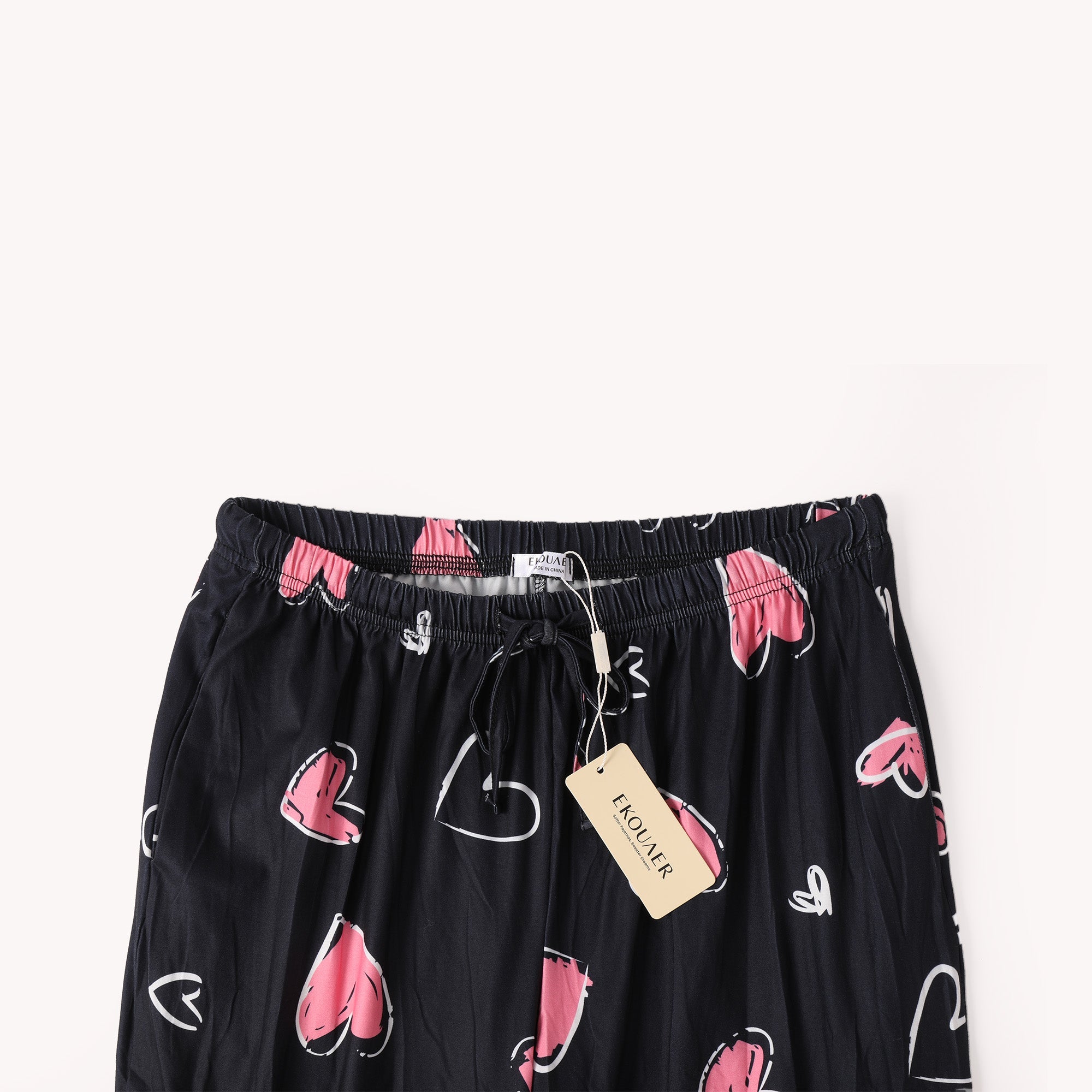 Black heart-printed pants waistband with pink hearts, elastic band and drawcord