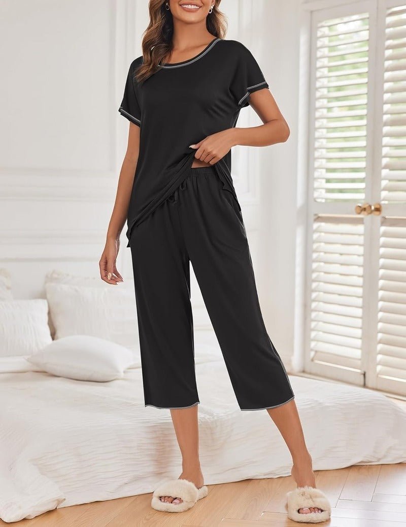 Black solid pajama set with short sleeves and cropped capri pants, pockets