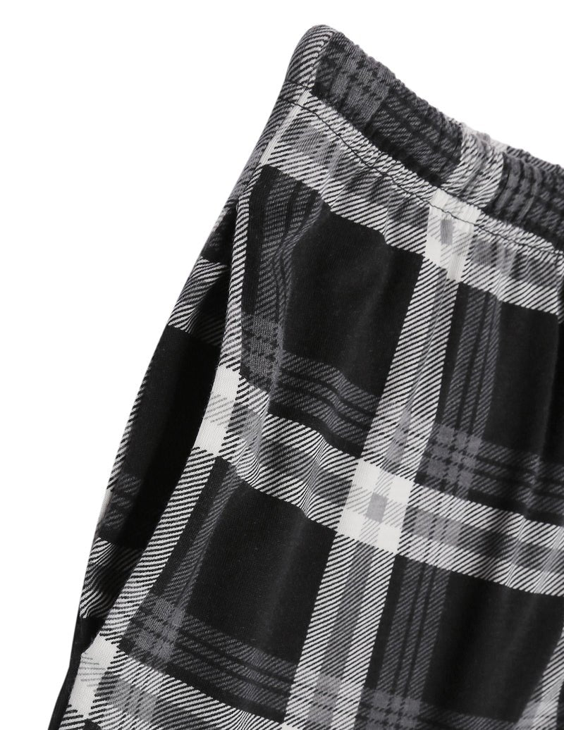 Close-up of grey-and-black buffalo plaid pajama fabric with elastic cuffs