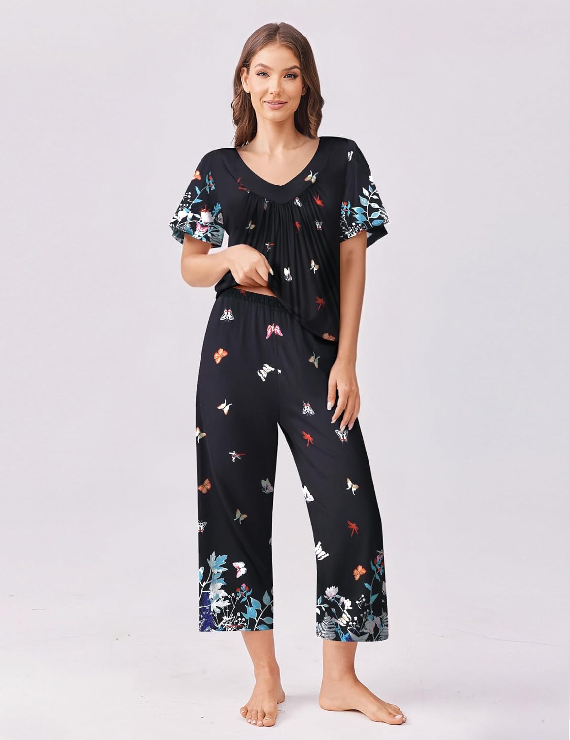 Black short-sleeve pajama top and capri pants set with colorful bird and floral motif