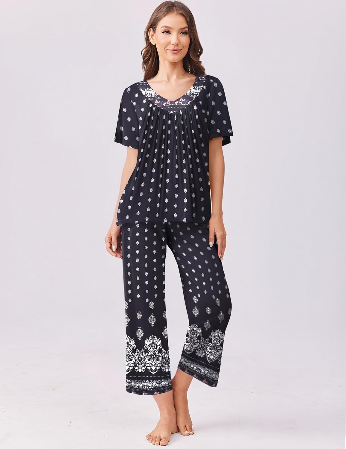 Black short-sleeve pajama top and capri pants set with small white dot print