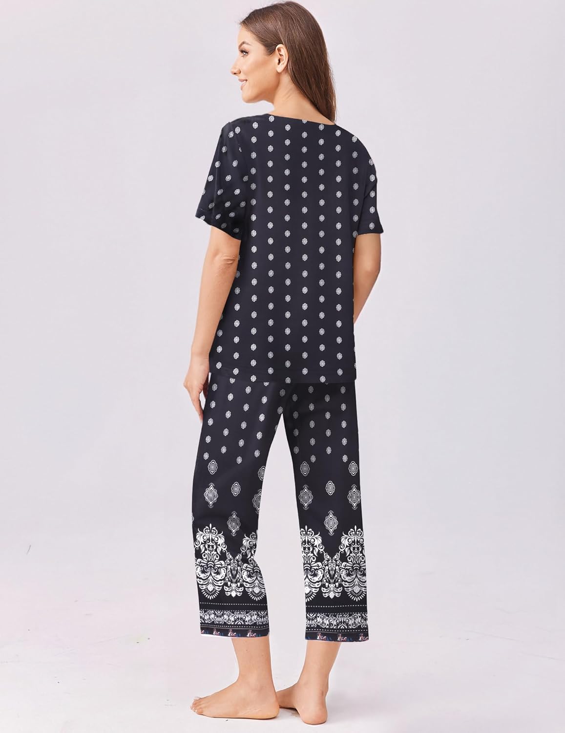 Black short-sleeve pajama set with capri pants and dotted border print, back view