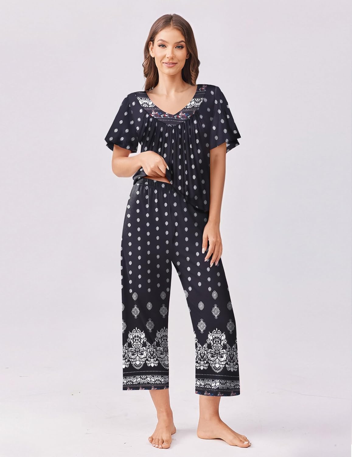 Black short-sleeve V-neck pajama top and capri pants set with small white dots