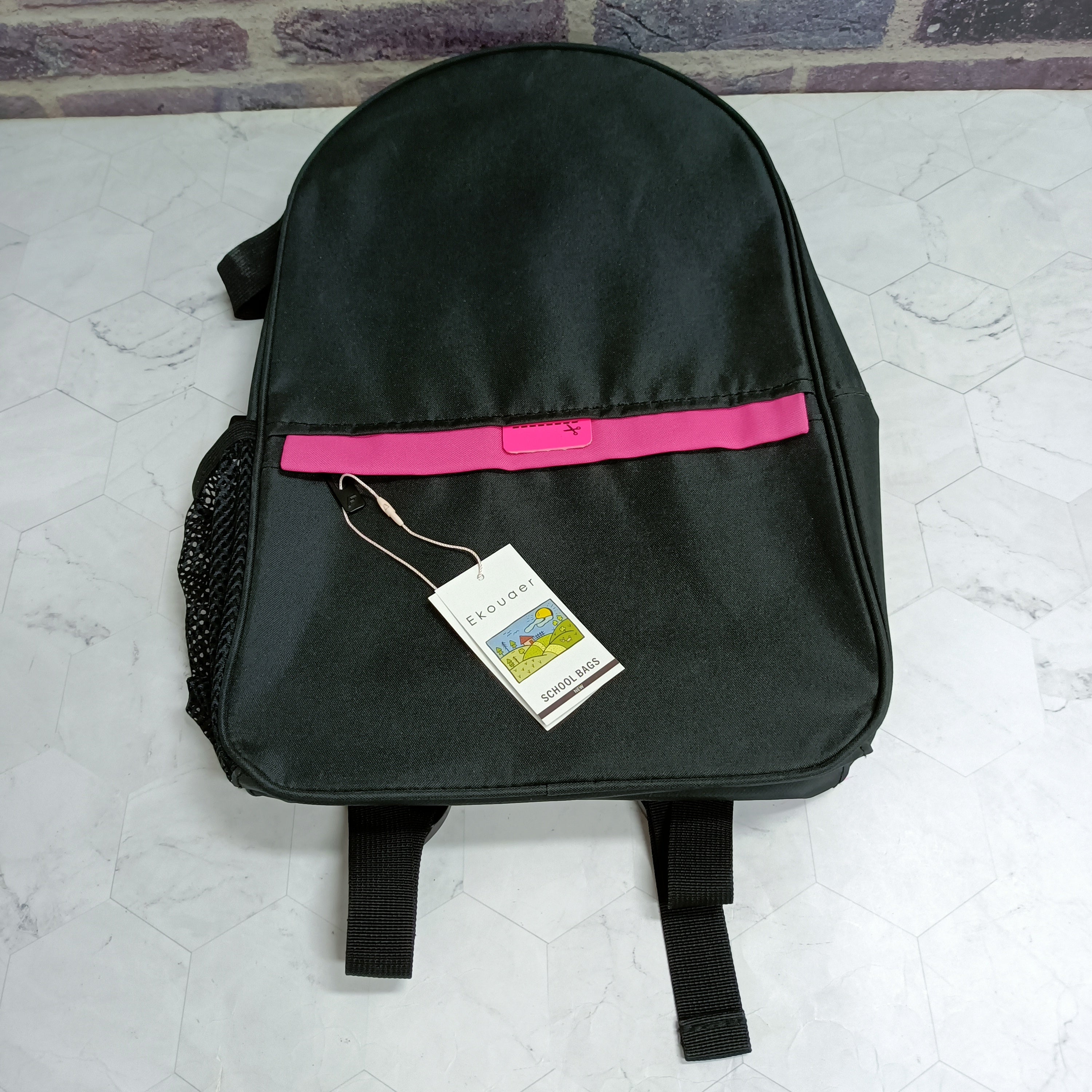 Black backpack front view with pink accent bar, front pocket and hanging tag