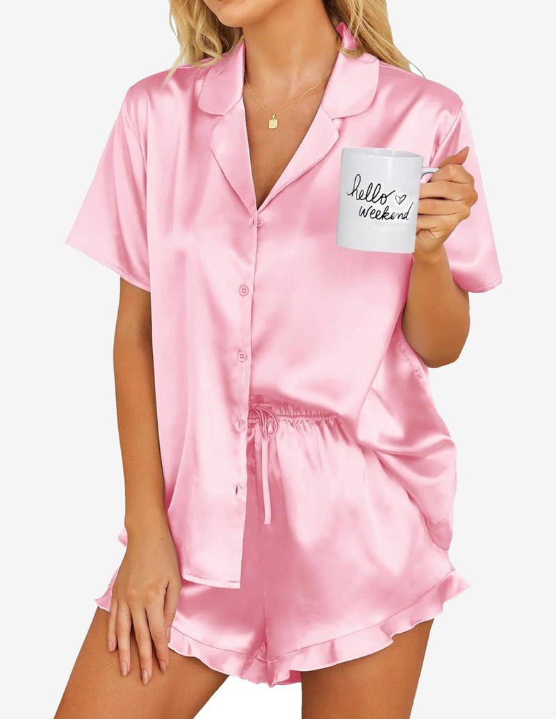 Girls pink satin pajama set, button-up short sleeve top and matching ruffle shorts