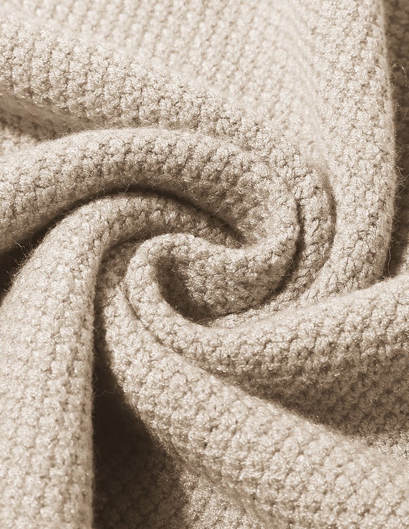 Close-up of cream textured knit fabric with soft looped yarn